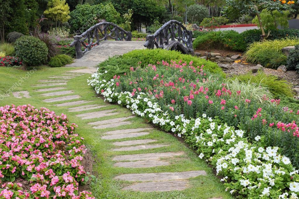 Landscape of floral gardening with pathway and bridge in garden Stock Photo by ©Sutichak 69537769
