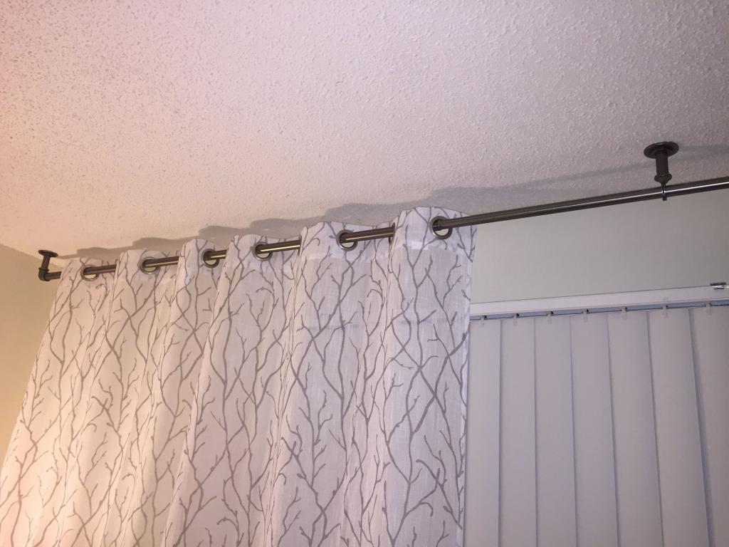 Need drapes to hang over vertical blinds? Mount rod to ceiling. Rod from Target. | Living room blinds, Blinds design, Fabric blinds