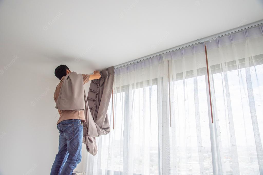 Premium Photo | Young man installing blind curtains over window in renovate inside house.