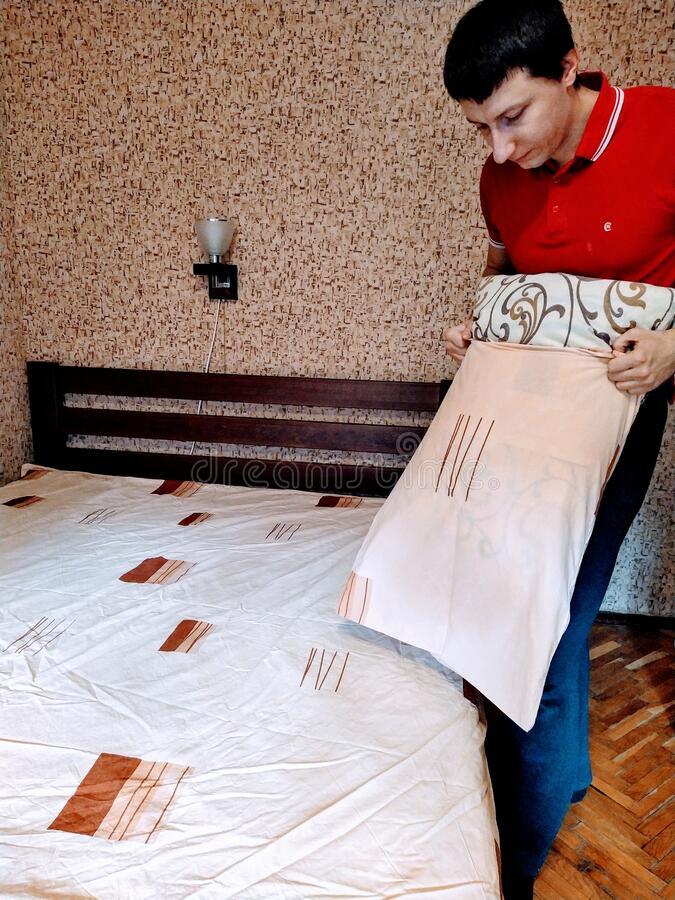 European Man Put Pillowcase on Pillow in Bedroom Stock Photo - Image of emotional, furniture: 181762394