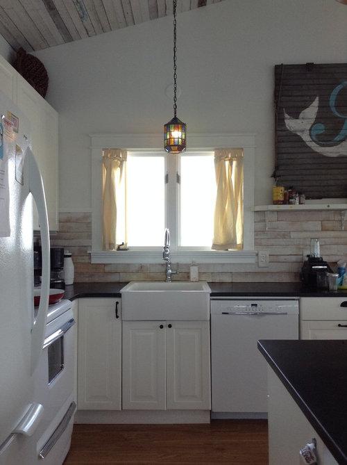 Proper curtain placement above kitchen sink